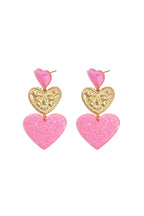 Orecchini vistosi con cuori glitterati